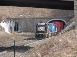 Black and blue pushers enter the tunnel with a stack train eastbound